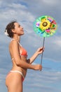 Woman standing and holding pinwheel toy Royalty Free Stock Photo