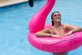 Woman standing on an inflatable ring floating in the pool Royalty Free Stock Photo