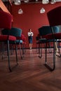 Woman standing infront chairs in office