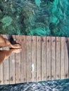 Woman standing on the jetty with beautiful clear water from the surface in Mabul Island, Semporna. Tawau, Sabah. Malaysia. Royalty Free Stock Photo