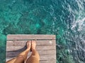 Woman standing on the jetty with beautiful clear water from the surface in Mabul Island, Semporna. Tawau, Sabah. Malaysia. Royalty Free Stock Photo