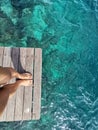 Woman standing on the jetty with beautiful clear water from the surface in Mabul Island, Semporna. Tawau, Sabah. Malaysia. Royalty Free Stock Photo