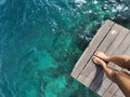 Woman standing on the jetty with beautiful clear water from the surface in Mabul Island, Semporna. Tawau, Sabah. Malaysia. Royalty Free Stock Photo