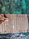 Woman standing on the jetty with beautiful clear water from the surface in Mabul Island, Semporna. Tawau, Sabah. Malaysia. Royalty Free Stock Photo