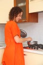 Woman standing in the kitchen and prepare food