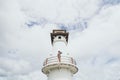 Woman standing on lighthouse in Baan Bang Bao fisherman village on Koh Chang island, Thailand