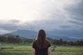 A woman standing and looking at a beautiful rice field onward with feeling relaxed Royalty Free Stock Photo