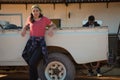 Woman standing while man filling petrol in car Royalty Free Stock Photo