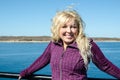 Woman standing on the Marthas Vineyard ferry, enjoying the wind blowing her blonde hair Royalty Free Stock Photo