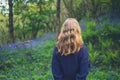 Woman standing in meadow of bluebells Royalty Free Stock Photo