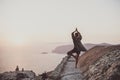 Woman standing and meditating in Monolithos, Rhodes, Greece