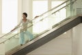 Woman Standing On Modern Glass Stairs