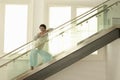 Woman Standing On Modern Glass Stairs