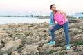 Woman standing after morning running on the rocks by the sea Royalty Free Stock Photo