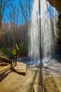 Woman standing near Moore Cove Waterfall in Pisgah National Forest near Brevard NC