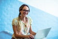 Woman standing near staircase and using laptop in office Royalty Free Stock Photo