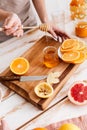 Woman standing near table with citruses and holding honey. Royalty Free Stock Photo