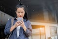 Woman is standing outdoors, using mobile phone Royalty Free Stock Photo