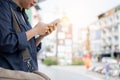 Woman is standing outdoors, using mobile phone Royalty Free Stock Photo