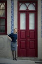 A woman standing outside a town house in Porto, Portugal. Royalty Free Stock Photo