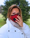 Woman wearing a red antiviral face mask to protect from sickness.