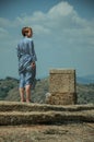 Woman standing over rocky hilltop at Monsanto