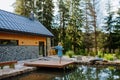 Woman, standing on a pier,near private lake, relaxing, enjoying cup of morning coffee on summer vacation in mountains. Royalty Free Stock Photo