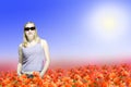 Woman standing on poppy flowers field Royalty Free Stock Photo