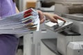 Woman standing and pressing button button on panel of printer, printer scanner laser office copy machine supplies in the office Royalty Free Stock Photo