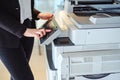 Woman pressing button on a copy machine in the office Royalty Free Stock Photo