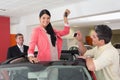 Woman standing in red cabriolet and man taking picture Royalty Free Stock Photo