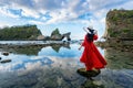 Woman standing on the rock at Atuh beach, Nusa penida island in Bali, Indonesia