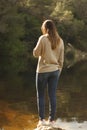 Woman standing on a rock near the lake