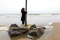 Girl rain sea wind winter portrait woman smile spring coat long hair curly mood shore snow beach autumn deadpan Royalty Free Stock Photo