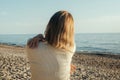 Woman Standing on Beach Next to Ocean