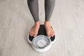 Woman standing on scales. Overweight problem