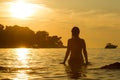 Woman standing in shallow at sunset Royalty Free Stock Photo