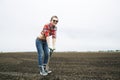 Woman standing on sharp shovel and smile