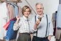 Woman standing with shopping bags and man showing a credit Royalty Free Stock Photo