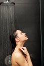 Woman standing at the shower. Royalty Free Stock Photo