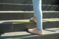 Woman standing on stairs with taped floor marking for social distance, closeup. Coronavirus pandemic