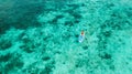 Woman standing on sup board. Turquoise water drone