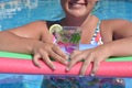 Woman outdoors, holding glass of sparkling water in a plastic cup