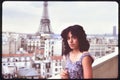 Young woman on terrace with view on Eiffel Tower