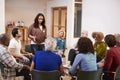 Woman Standing To Address Self Help Therapy Group Meeting In Community Center Royalty Free Stock Photo