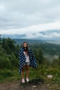 Woman standing on top of a hill, against the background of a valley Royalty Free Stock Photo