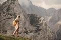 Woman standing at the top of the hill in mountains looking at wonderful scenery. Triglav, the highest slovenian mountain. Trgilav