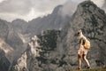 Woman standing at the top of the hill in mountains looking at wonderful scenery. Triglav, the highest slovenian mountain. Trgilav