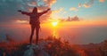 A woman standing on top of a mountain with her arms outstretched at sunset Royalty Free Stock Photo