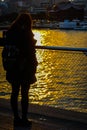 Woman standing in the twilight of the large pier